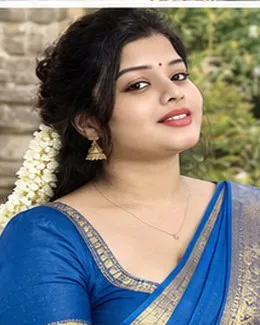 Kavya in a blue silk saree, gold earrings and a red bindi